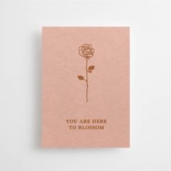 Pink card with text you are here to blossom