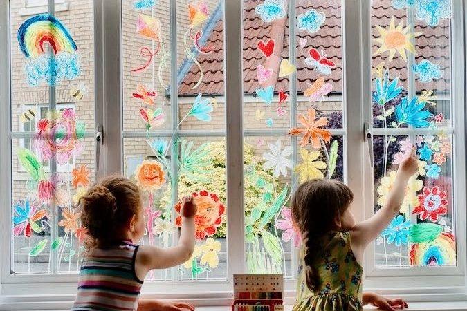 children draw with window chalk on window