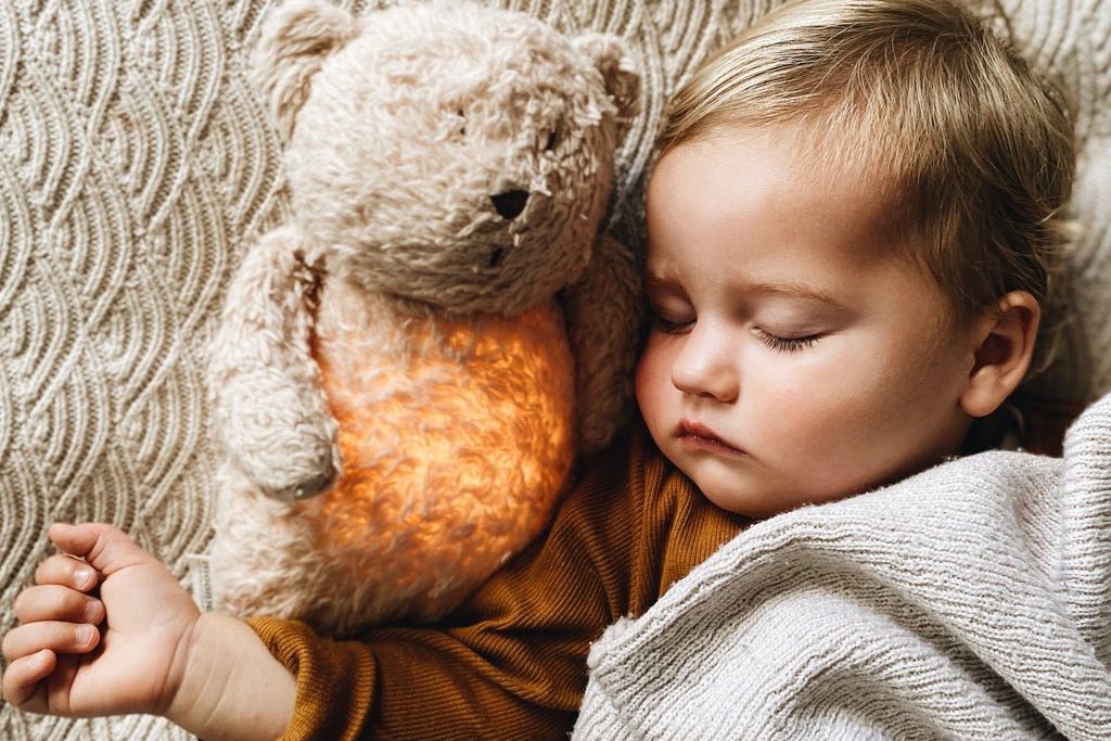 Child with stuffed bear made of organic cotton