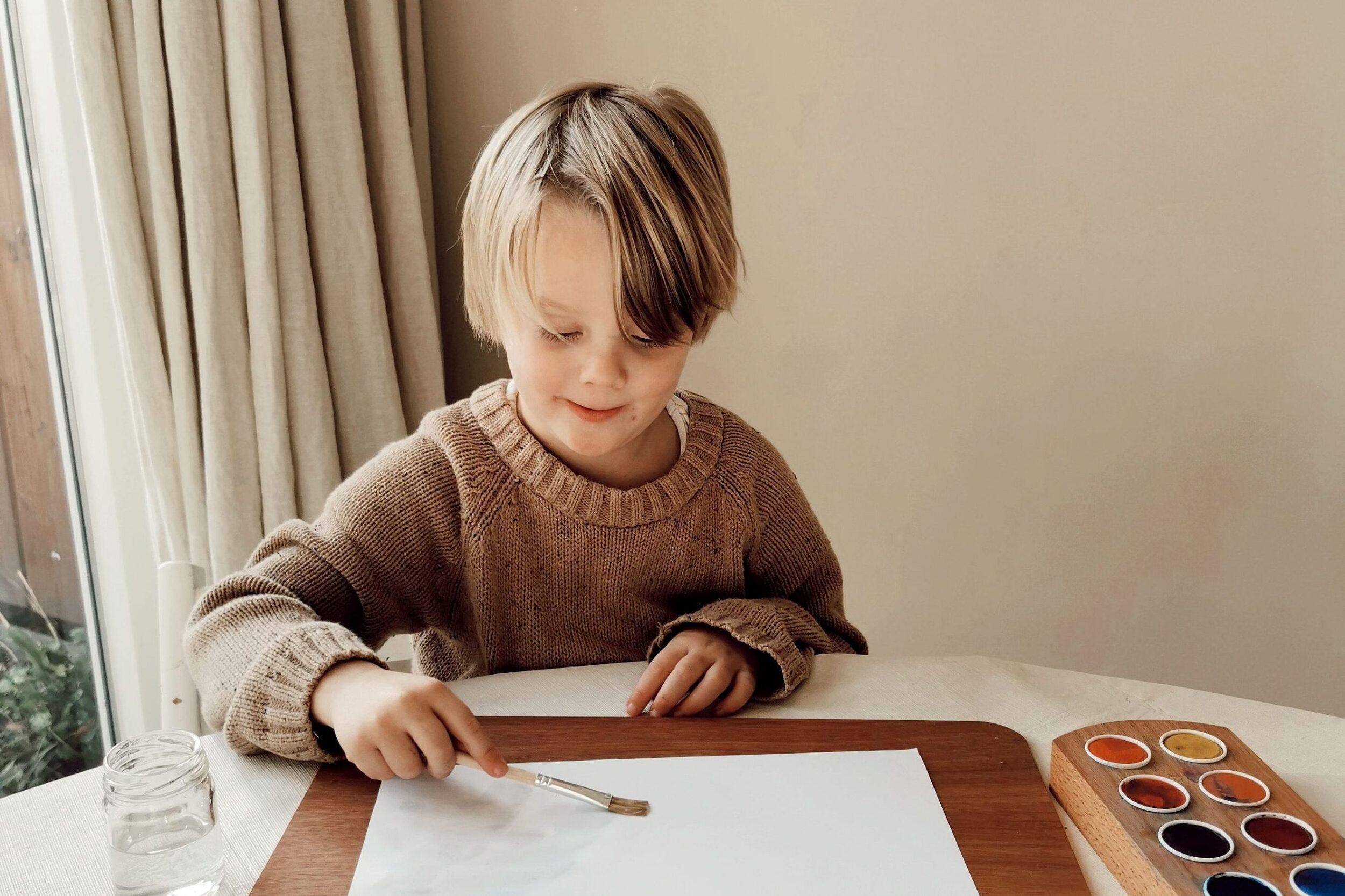 Child Painting on Wooden Drawing Board